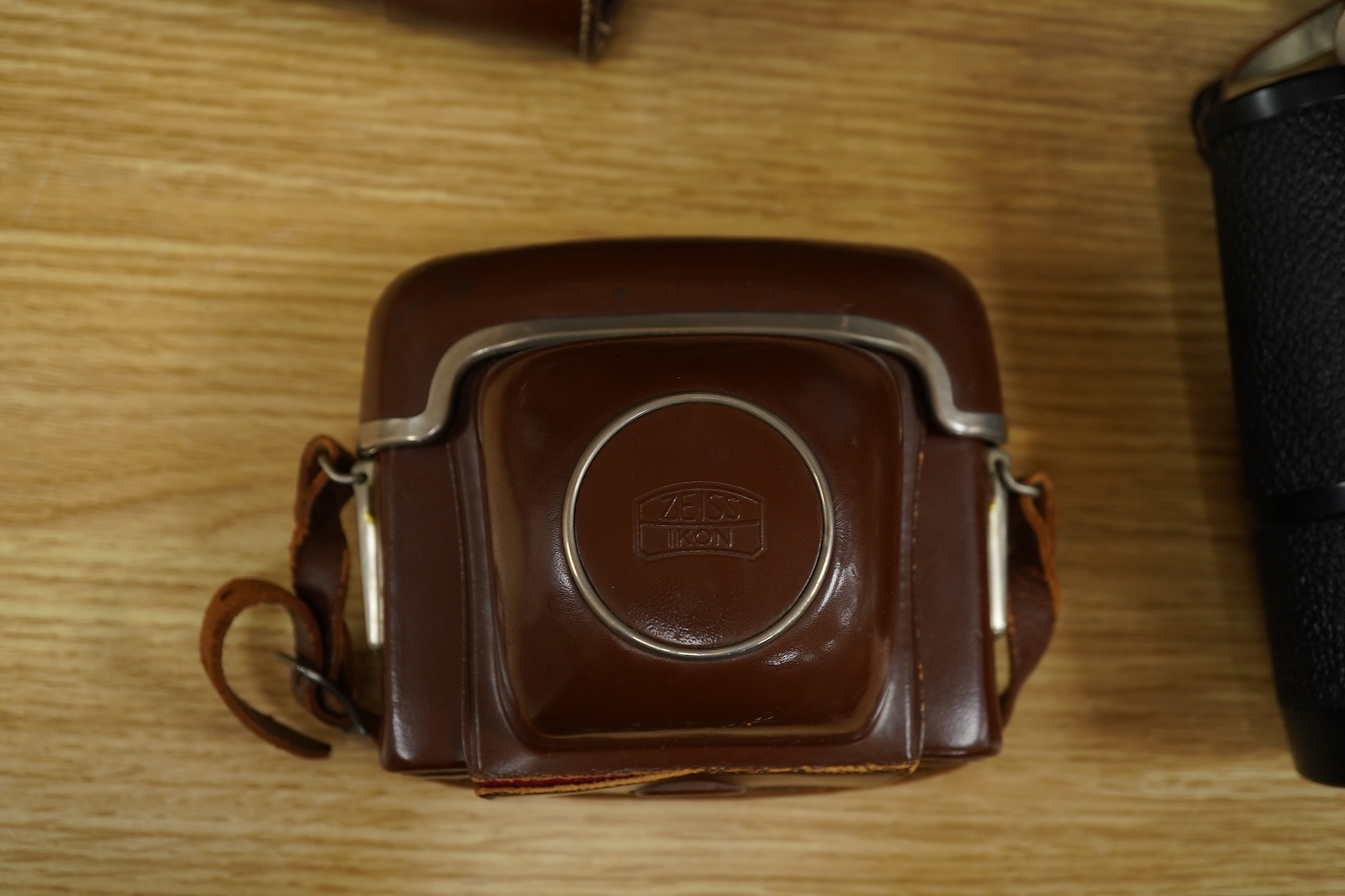 A leather cased telescope, a Zeiss Ikon camera and cased Zeiss Decarem 10 x 50 binoculars- 20cm high plus original box, 20cm high
